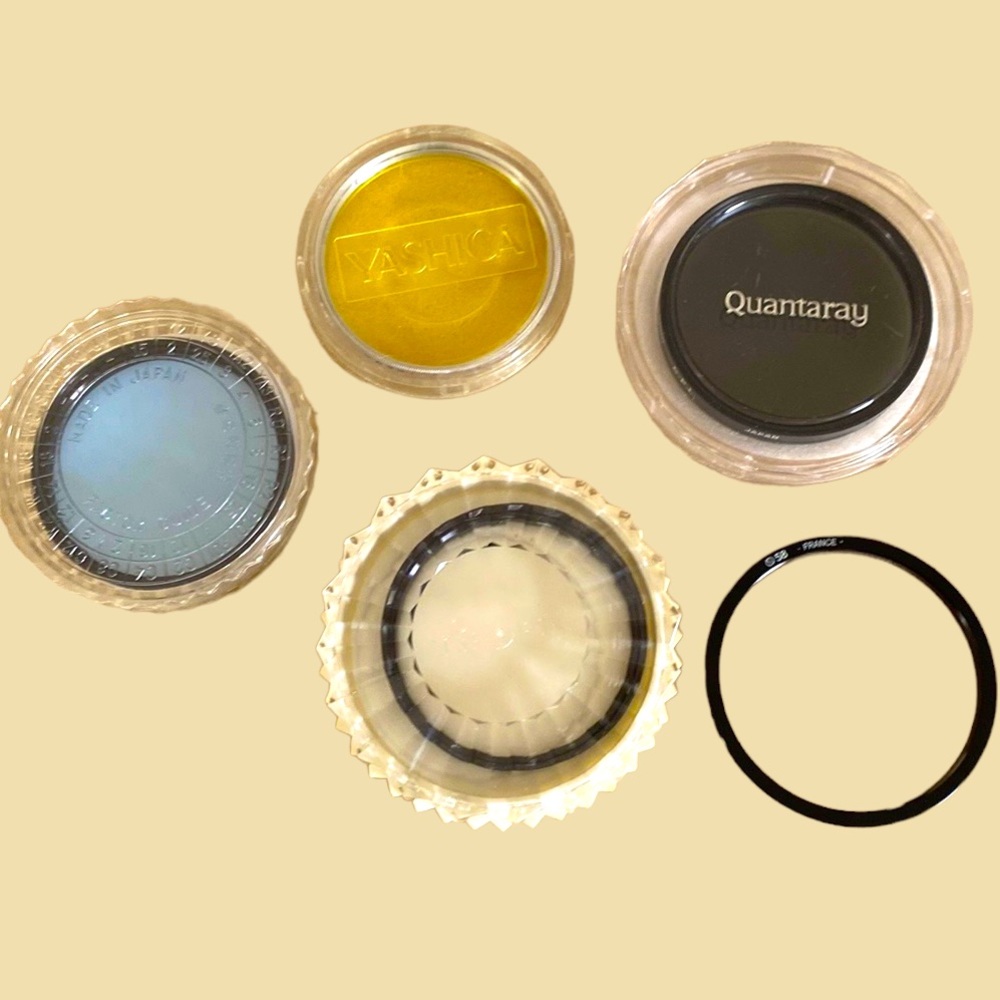 Set of 4 lens filters, adapter ring and Vivitar Tele Converter.